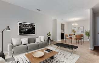 a living room with a gray couch and a wooden coffee table