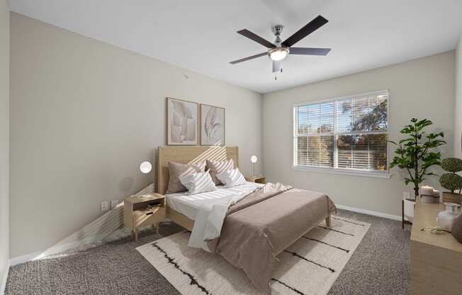 a bedroom with a large bed and a ceiling fan