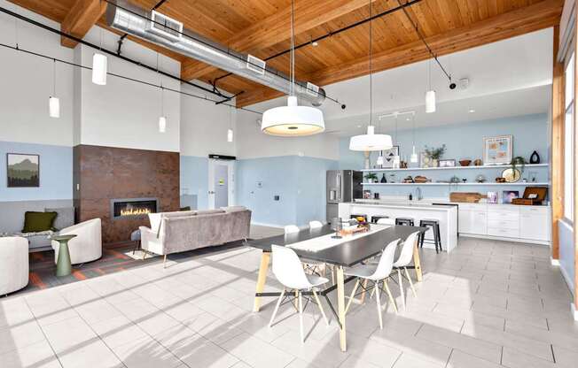 A modern open plan living and kitchen area with a dining table and chairs.