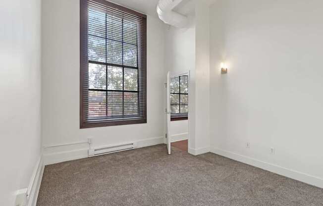 A room with a window and a chair.