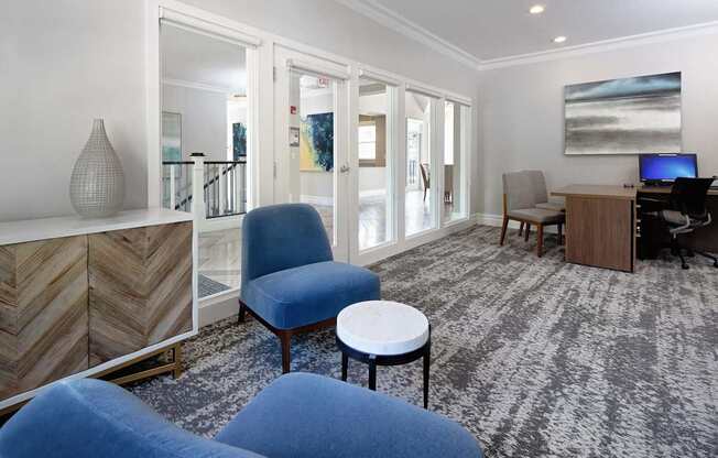 a living room with blue chairs and a table