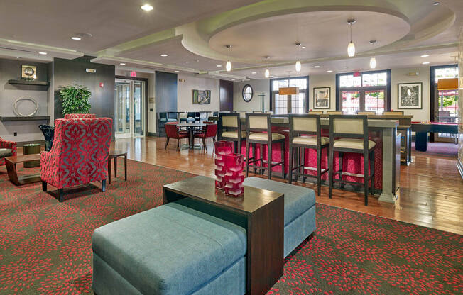 A large room with a green ottoman in the middle of it at Vermella Lyndhurst apartments, Lyndhurst, New Jersey