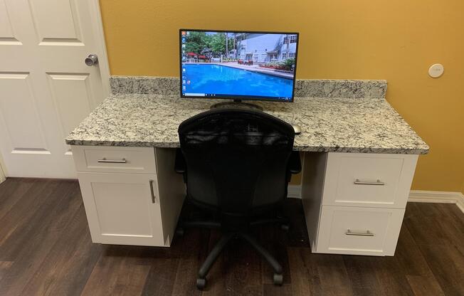 a desk with a computer