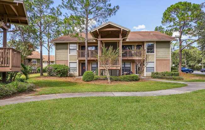 A row of houses with a tree in front of them.