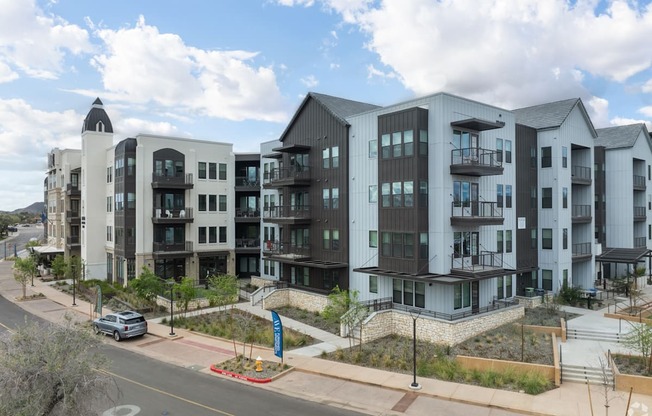 A modern apartment complex with multiple buildings and balconies.