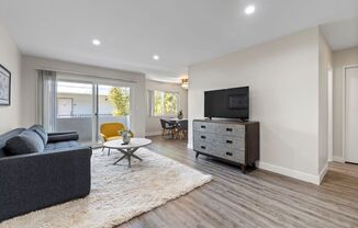 a living room with a couch and a tv on a dresser