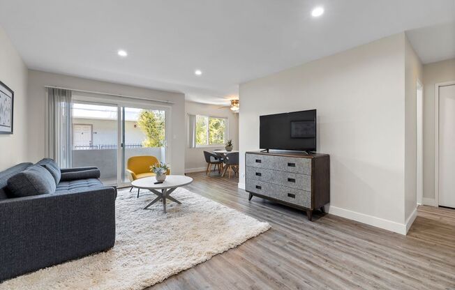 a living room with a couch and a tv on a dresser