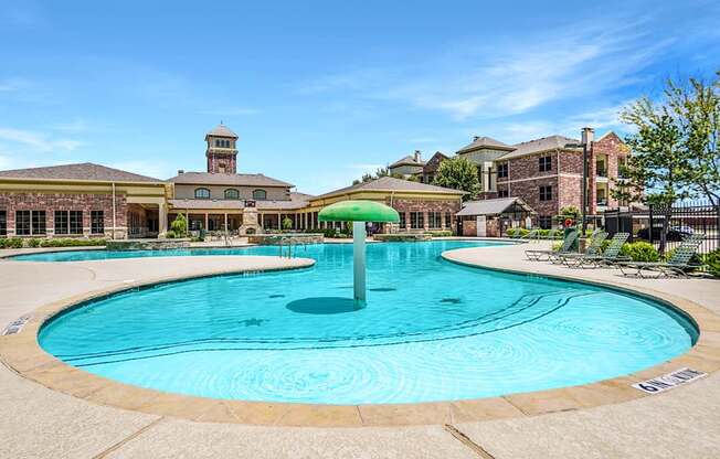 A large swimming pool with a waterfall in the middle of it.