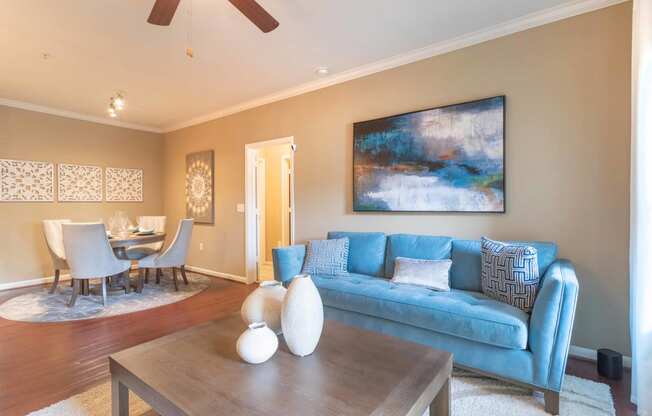 a living room with a blue couch and a coffee table