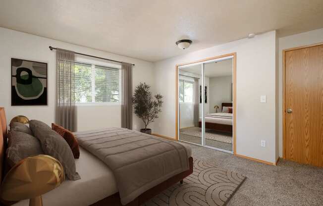 A bedroom with a bed, chair, and mirror.