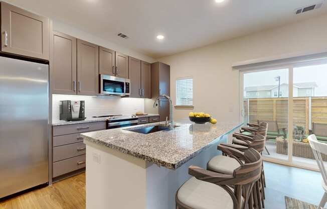 a kitchen with stainless steel appliances and a granite counter top