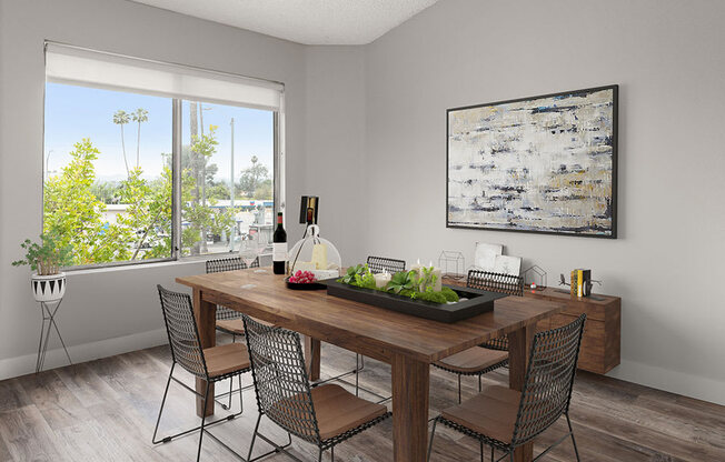 Hardwood floored dining room with view of grassy courtyard.