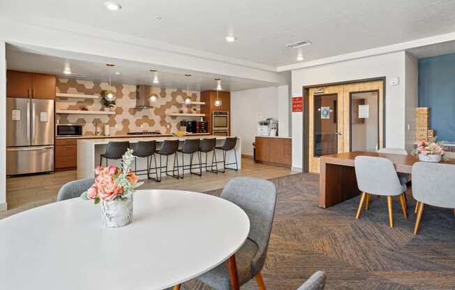 a dining room with a kitchen and a table with chairs