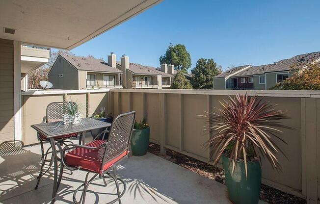 Patio with table and chair Apartments in Pittsburg, CA l Kirker Creek Apartments