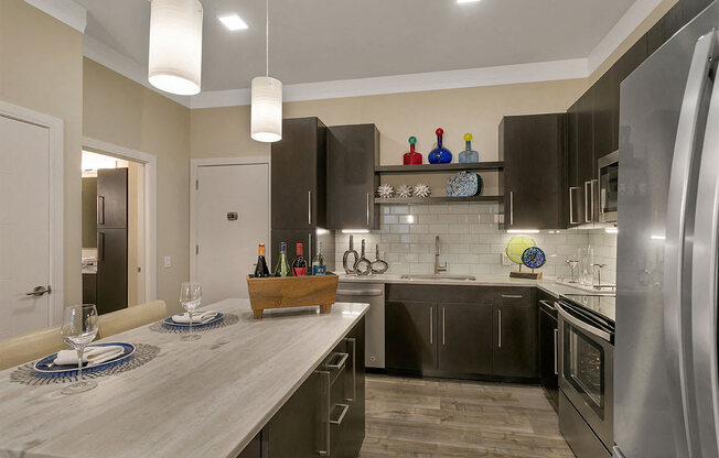 a kitchen with stainless steel appliances and a counter top at Aster Apartments, Ohio 