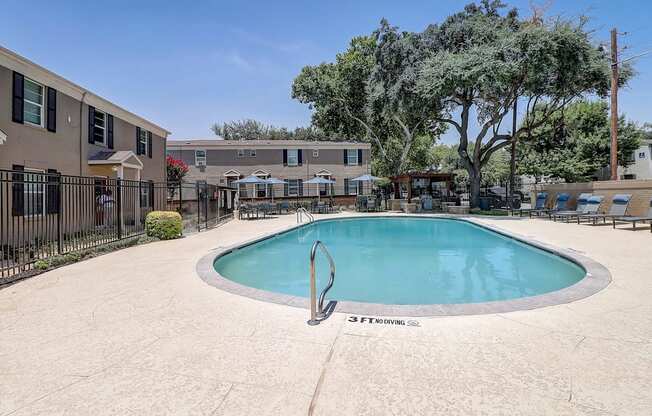 a resort style pool is next to an apartment building
