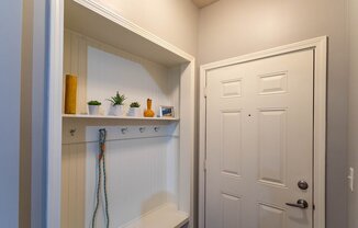 a laundry room with a closet and a white door