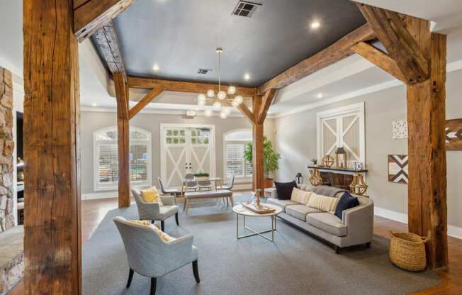 a living room with wooden beams and furniture and a fireplace