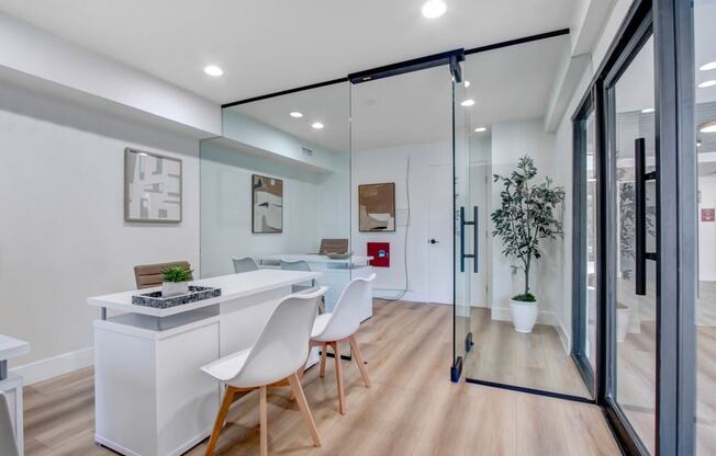 a dining area with a table and chairs and a sliding glass door