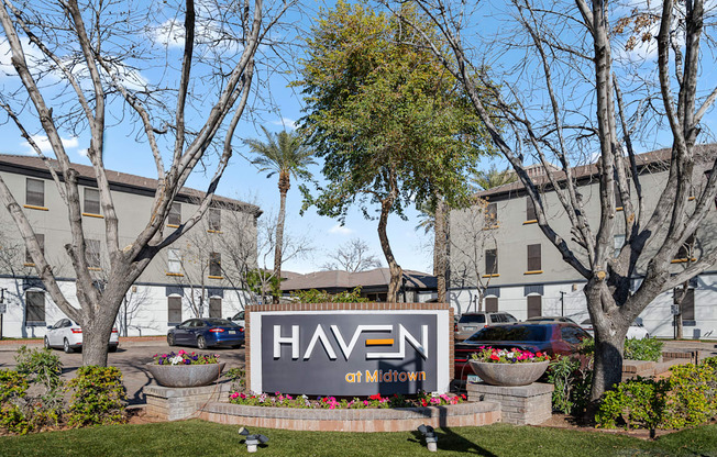 a large sign in front of a building with trees