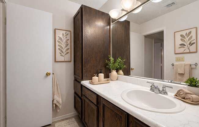 A bathroom with a white sink and a white door.
