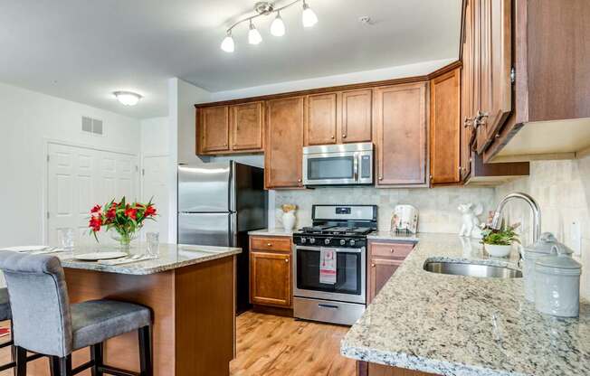 A kitchen with granite countertops and stainless steel appliances.