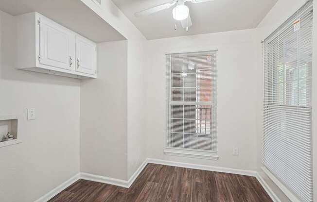 A room with a window and a fireplace.