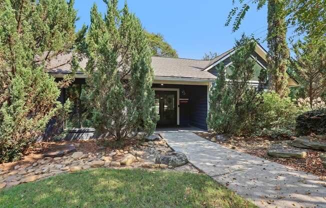 A house with a stone pathway leading to a garage.