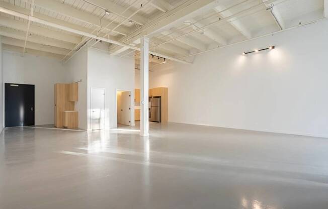 a large room with white walls and wood furniture