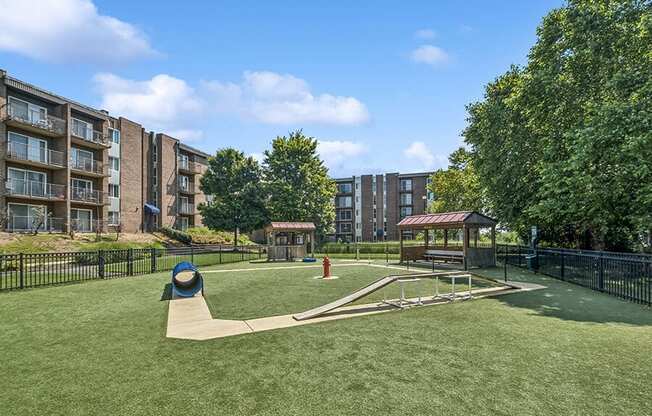 Community Dog Park with Agility Equipment at Mason Van Dorn Apartments located in Alexandria, VA.