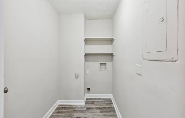 an empty room with white walls and a white closet and stairs