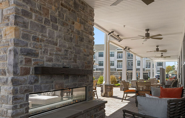 A patio with a stone fireplace and a ceiling fan at Madison Prickett Preserve, Pennsylvania