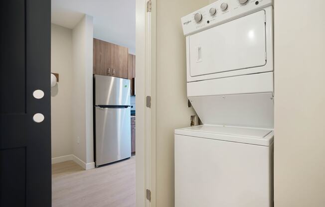 a white washer and dryer in a room with a refrigerator