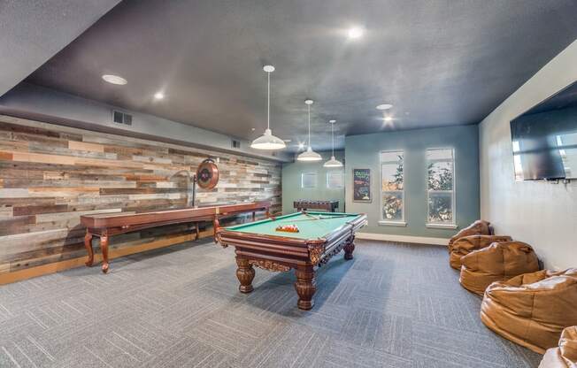 a game room with a pool table and ping pong