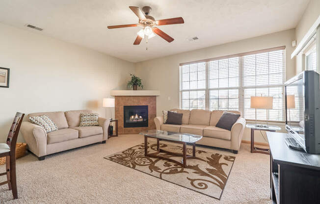 a living room with two couches and a fireplace