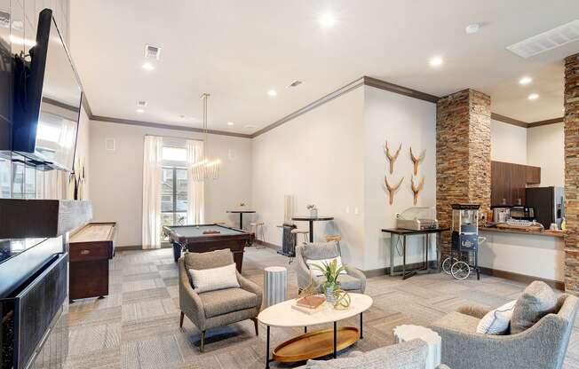 a clubhouse with a pool table and a living room