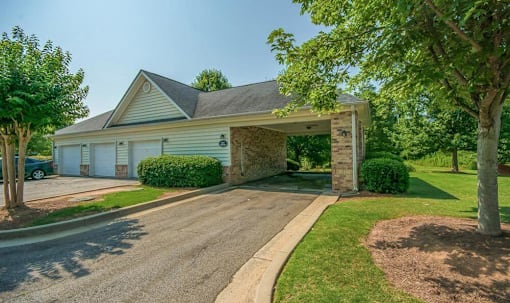 a home with a carport in front of a driveway