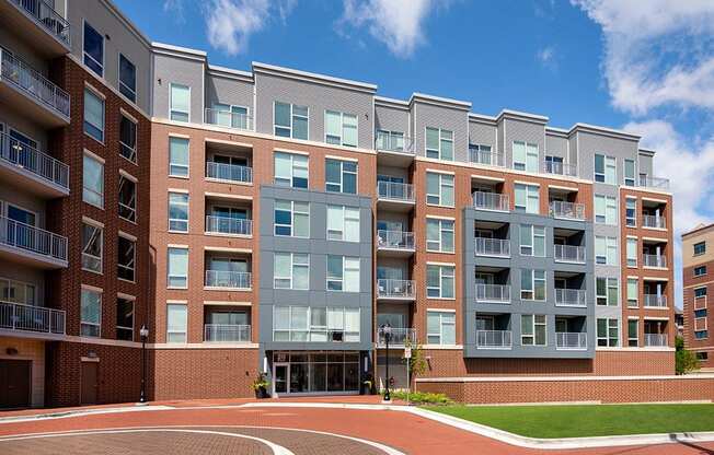 a large apartment building with a basketball court in front of it