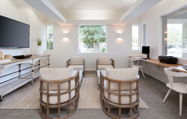 a living room with a table and chairs and a television