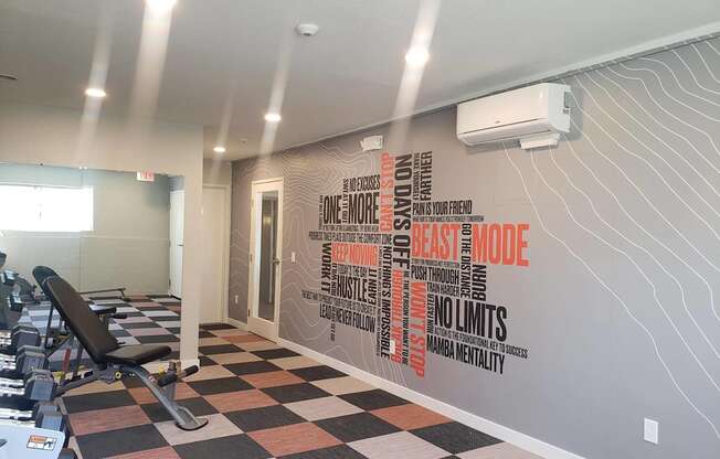 A gym with a wall of motivational quotes.