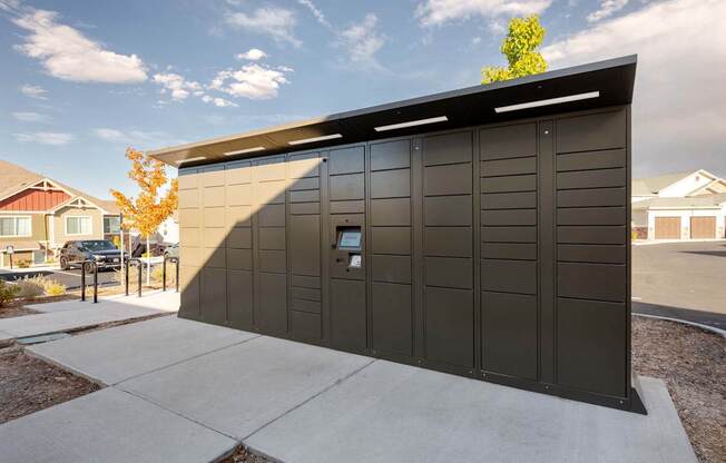 A black building with a tree in front of it.