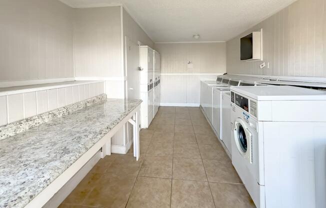 a kitchen with a counter top and a stove and a washing machine