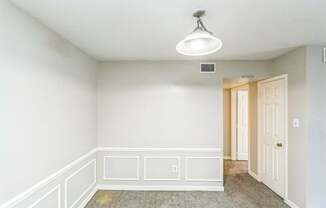 A room with white walls and a carpeted floor.