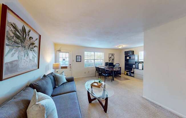 A living room with a couch, coffee table, and television.