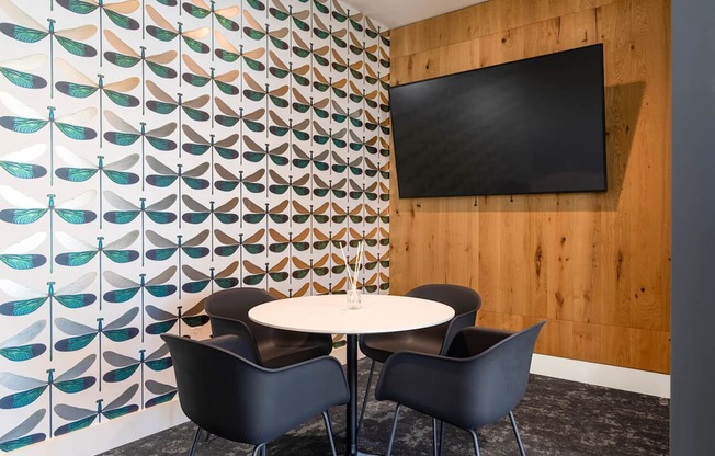 A wall with a pattern of feathers and a black screen on it.