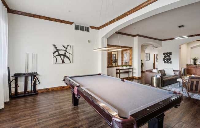 a living room with a pool table in the middle