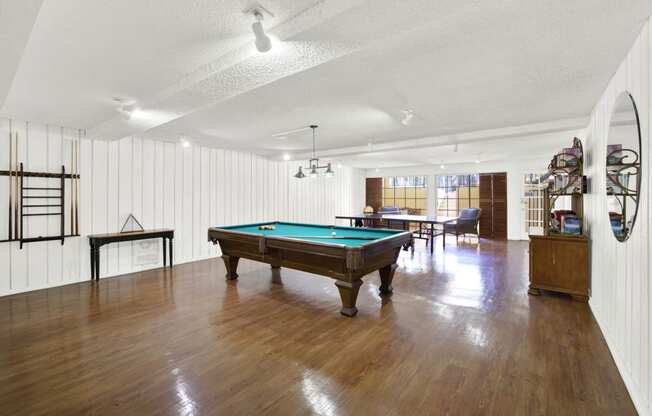 a room with a pool table in the middle of it at Camino de Oro Apartments, Torrance, California