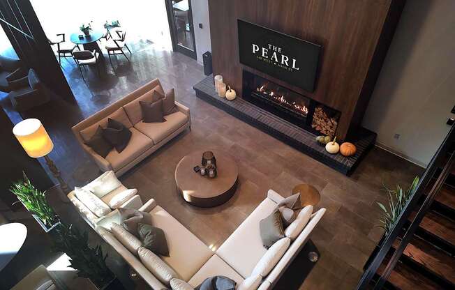 Lobby lounge with a fireplace and a couch at The Pearl, Indiana, 46802