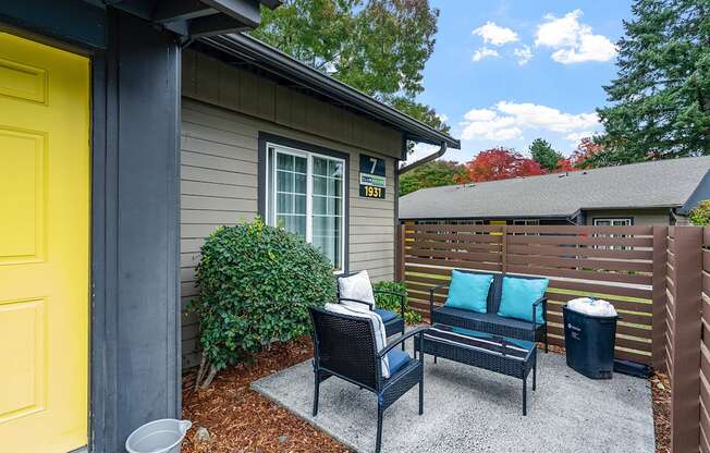 Outdoor patio with seating and wooden fence