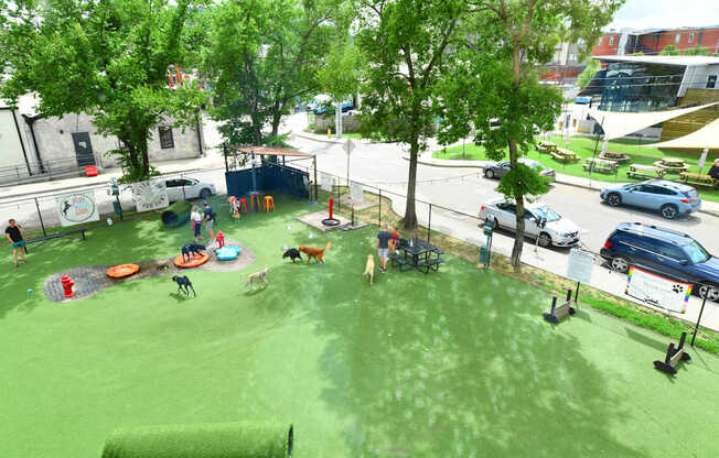 A playground with a green surface and children playing.